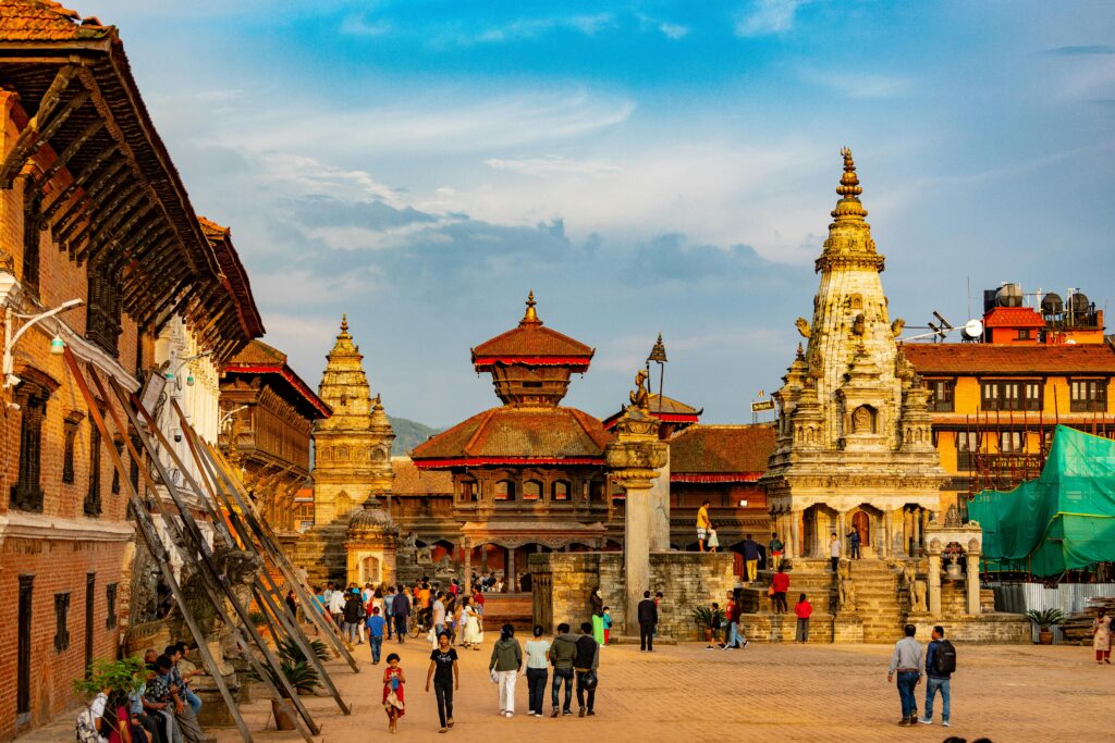 Explore the vibrant architecture and bustling life of Bhaktapur Durbar Square, Nepal in daylight.